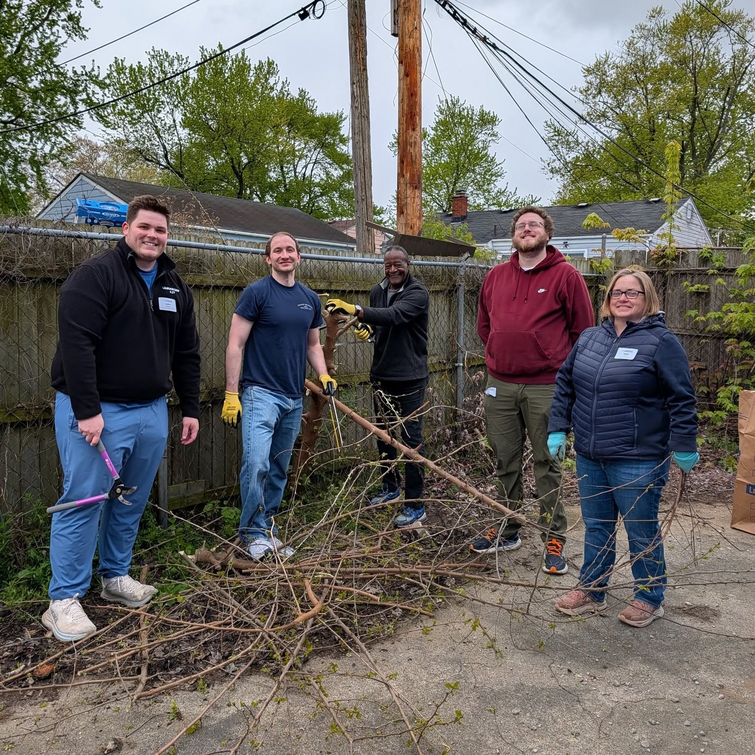Volunteers from the Ann Arbor/Ypsilanti Regional Chamber's Leadership Cohort 2026 doing yard cleanup at a Friends In Deed site